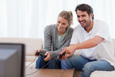 11681467-couple-playing-video-games-in-their-living-room.jpg